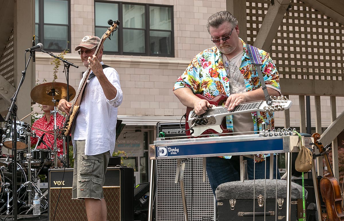 bass guitar player and steel guitar player on stage playing