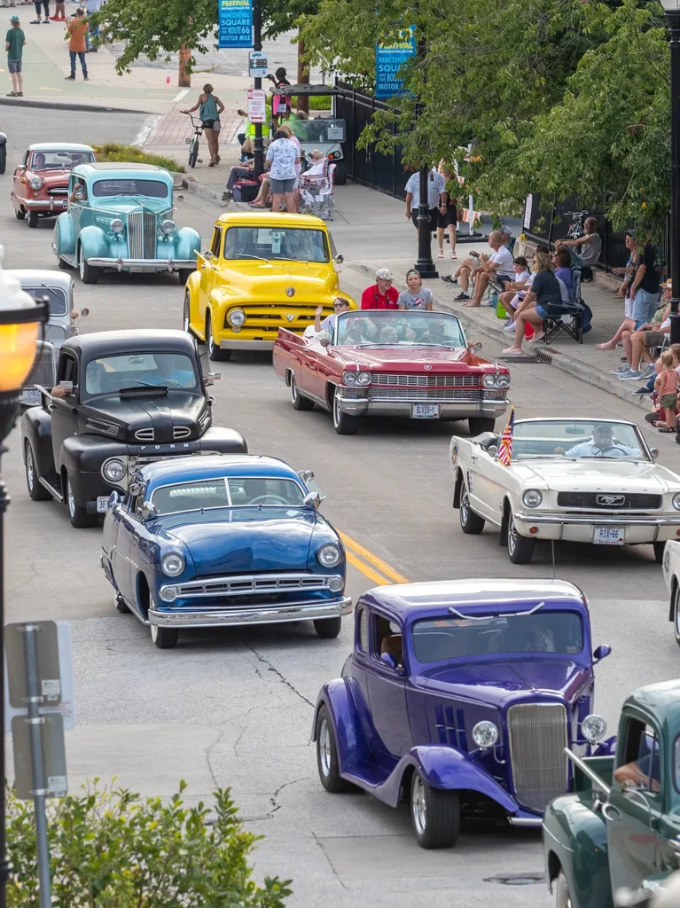 parade of classic cars in many colors